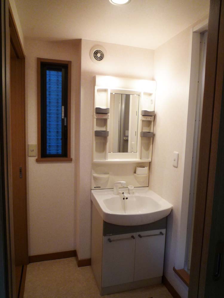 Washroom. Bright wash basin there is a window. Washbasin a shower. Left the toilet