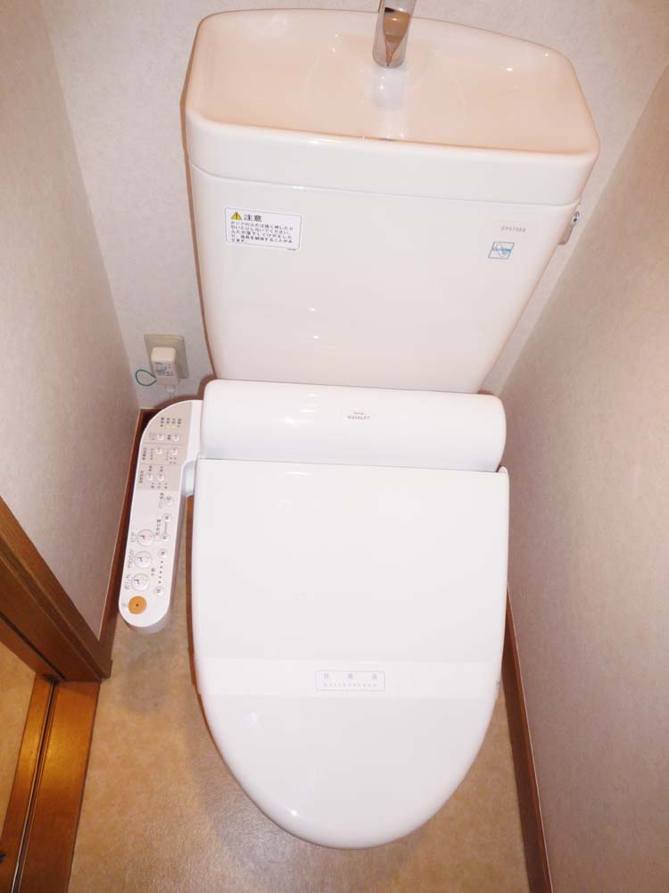 Toilet. It is with a cleaning toilet seat. There is a window on the right-hand side ventilation is also good. 