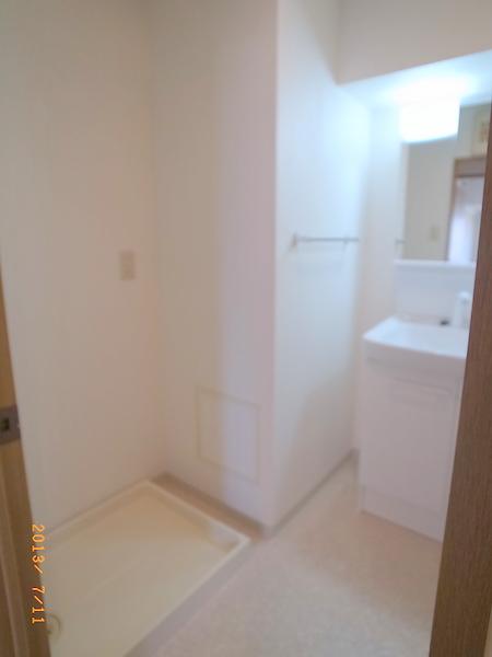 Wash basin, toilet. The apartment is a reference photograph.