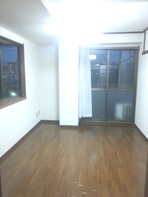 Living and room. This room of a bay window with a wooden floor in the corner room.