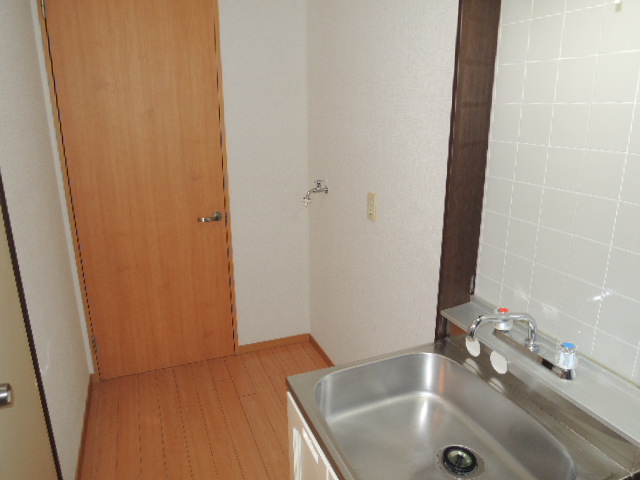 Other room space. Washing machine storage sink beside it and refrigerator